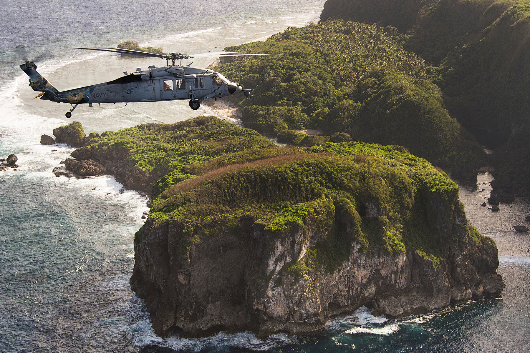 This is an image of an MH-60S Seahawk helicopter during an exercise off the coast of Guam.